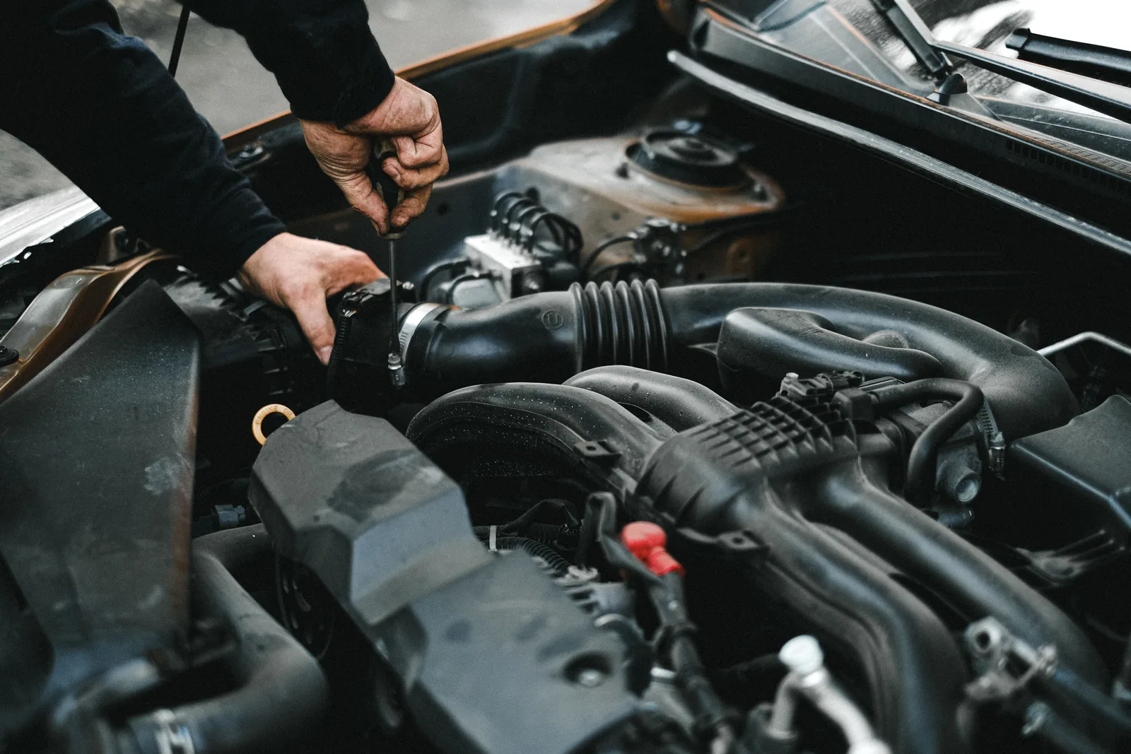 Mecánico revisando el motor de un coche en un taller